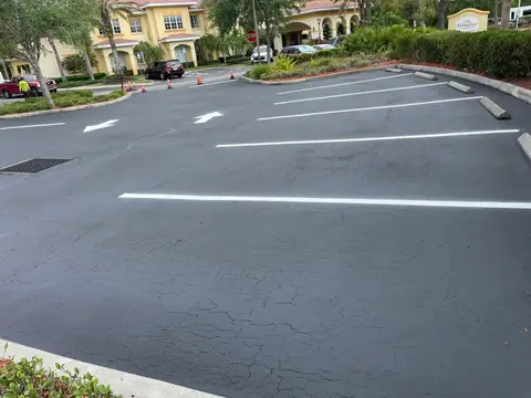 Freshly sealed parking lot with clear directional arrows